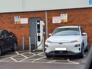 Hyundai Kona EV next to a EVSE charging station