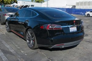 Tesla Model S on the side in a car park
