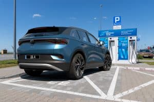 A VW Volkswagen ID.4 Electric SUV parked at a charging station