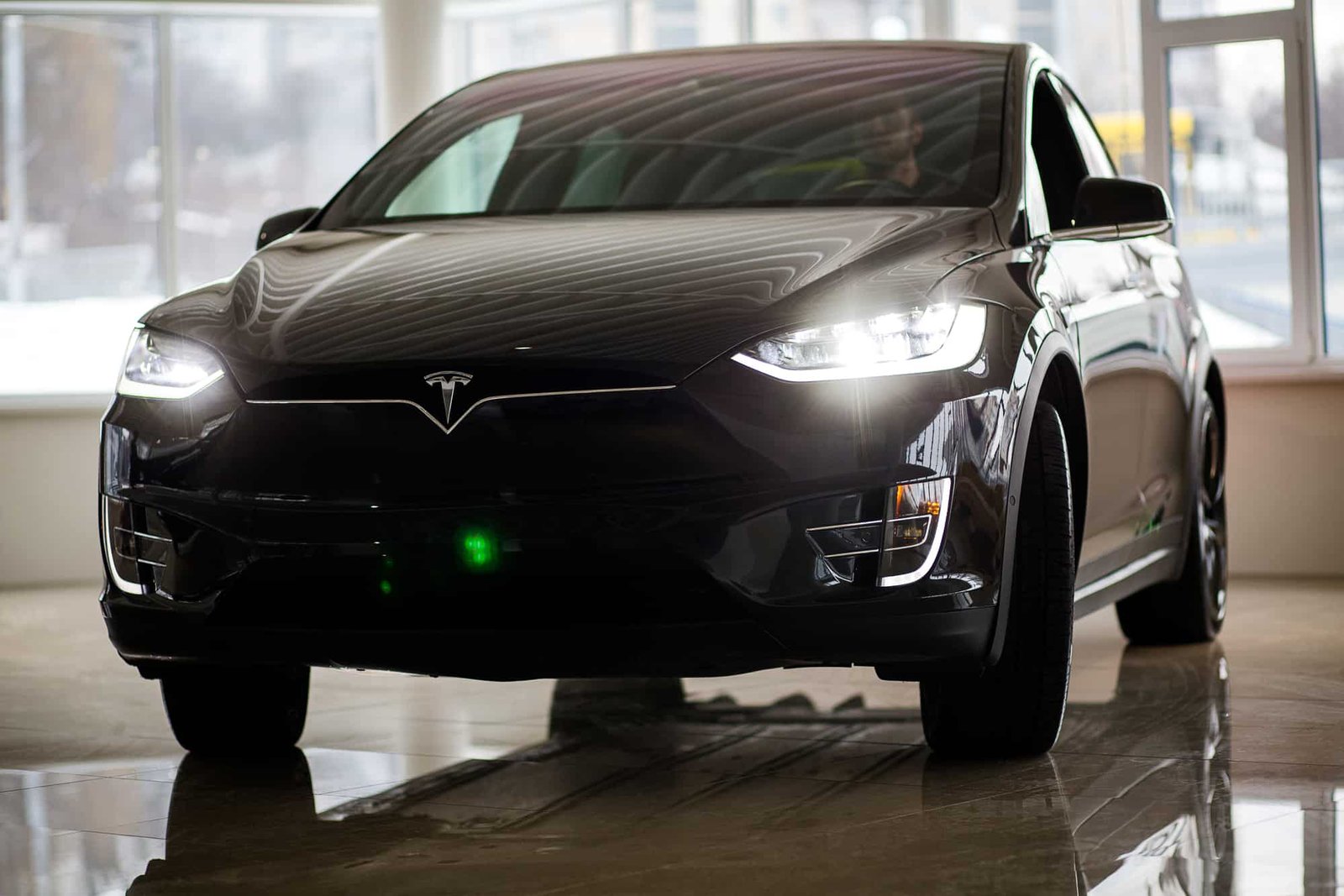 Why Tesla Lights Sometimes Flash On Their Own When Parked Green Car