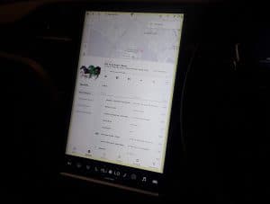 A Tesla touchscreen with a yellow band around its edge