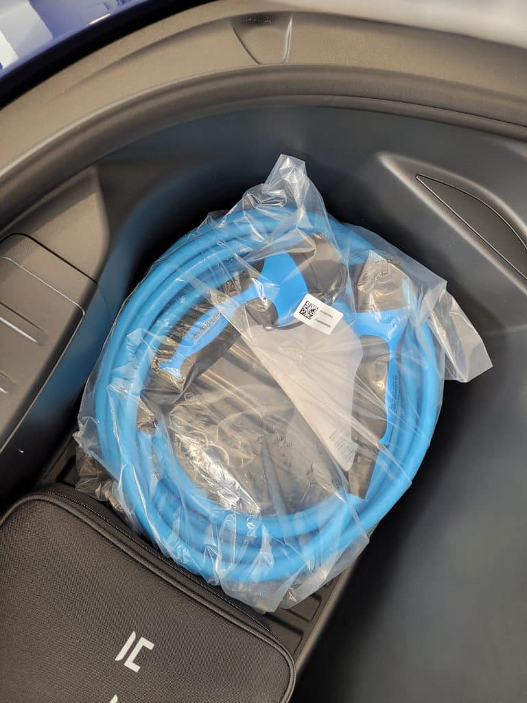 A MENNEKES My Power Connection charging cable inside a Tesla frunk