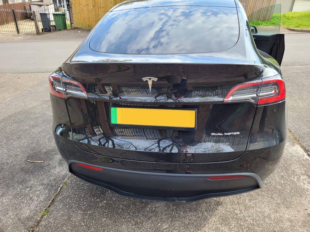 The back of a black Tesla Model Y Performance