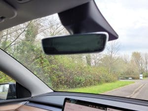 The rear view mirror inside a Tesla Model Y