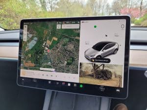 Touchscreen of a Tesla Model Y showing the navigation with map overlay