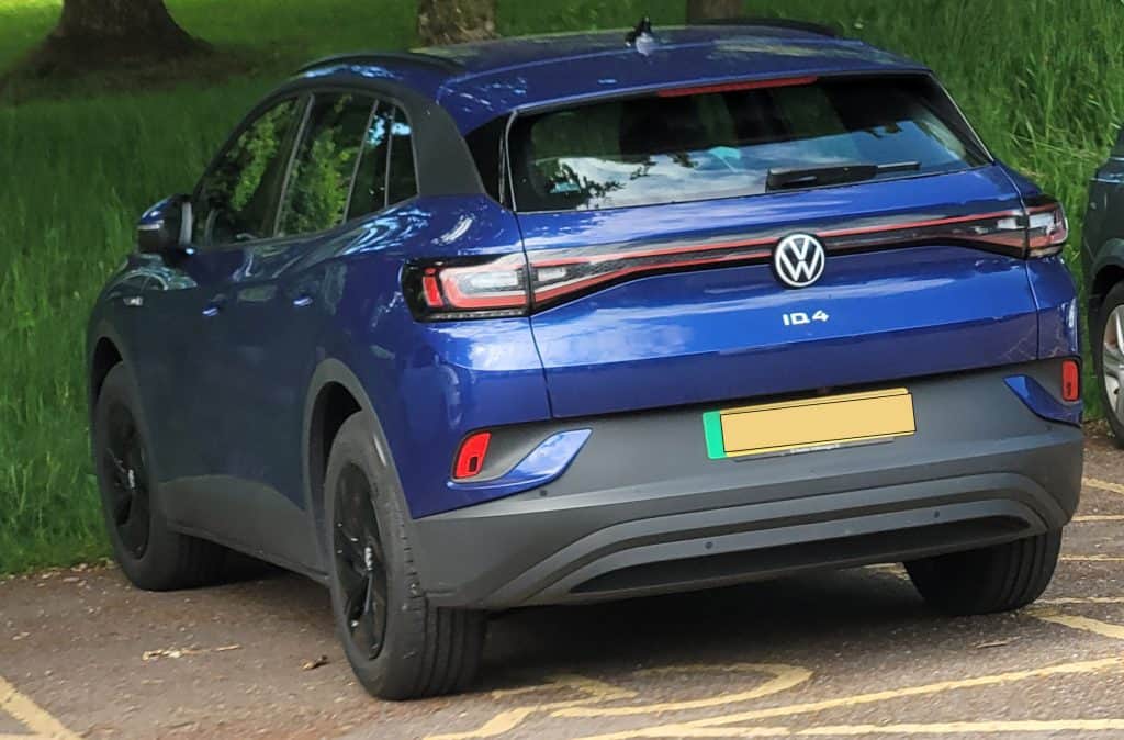 The back of a blue VW ID.4 part of the ID range parked up in the UK