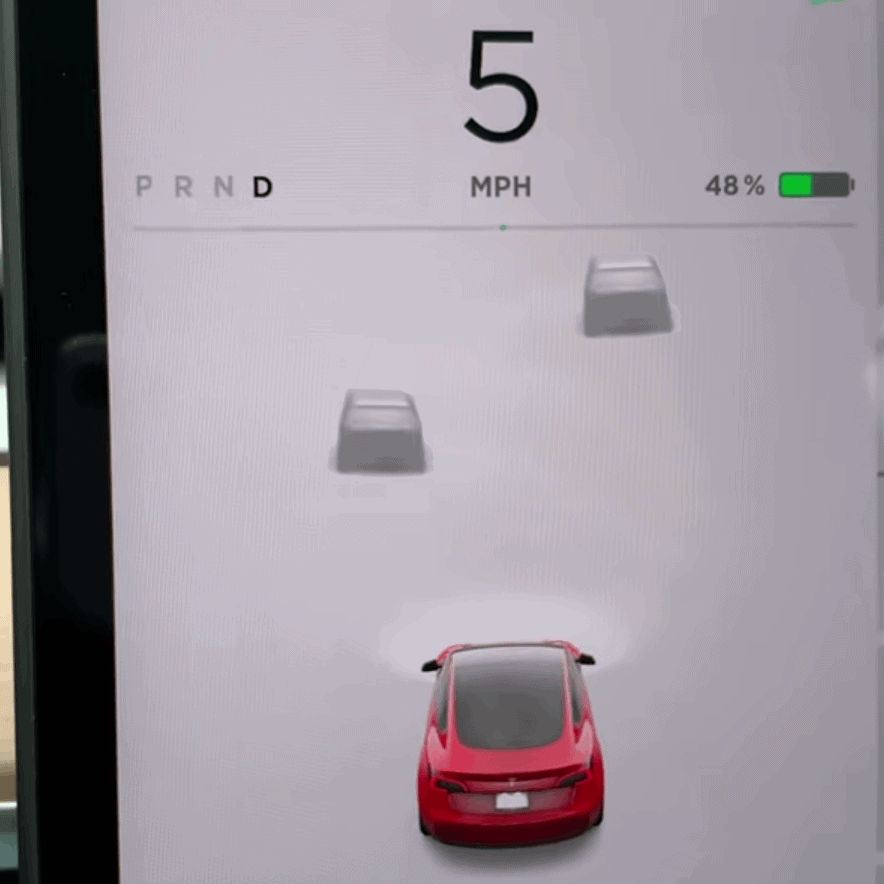 Tesla screen with two vehicles in front being shown